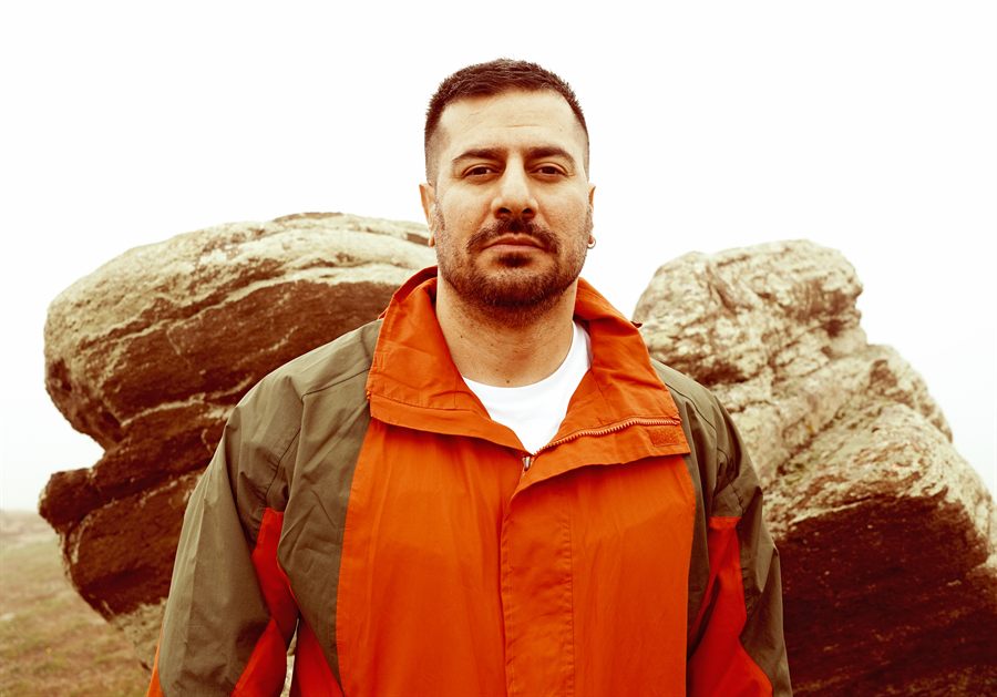 Behrouz Pashai, standing before weathered rocks in the mist